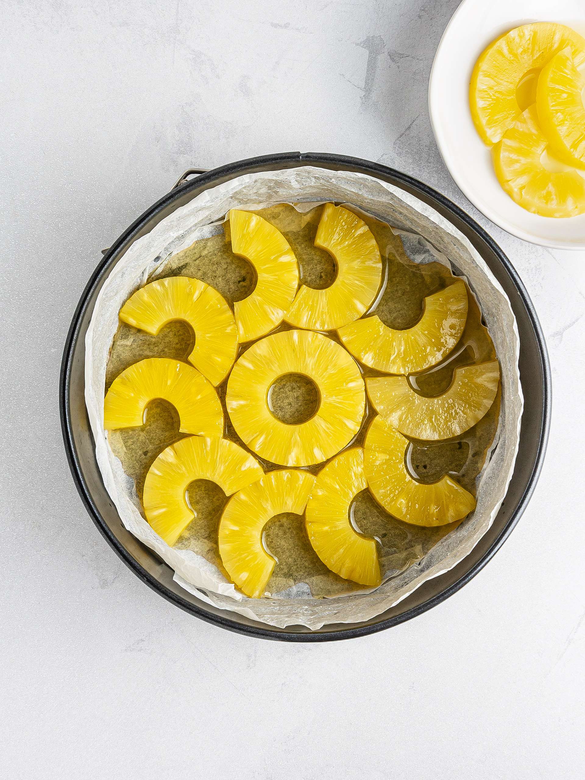 Pineapple slices on the bottom of the baking tin.