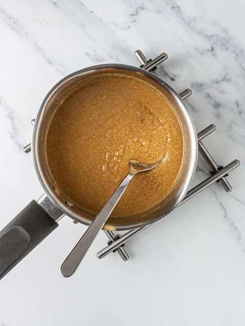 Maple syrup and almond butter melted in a pot.