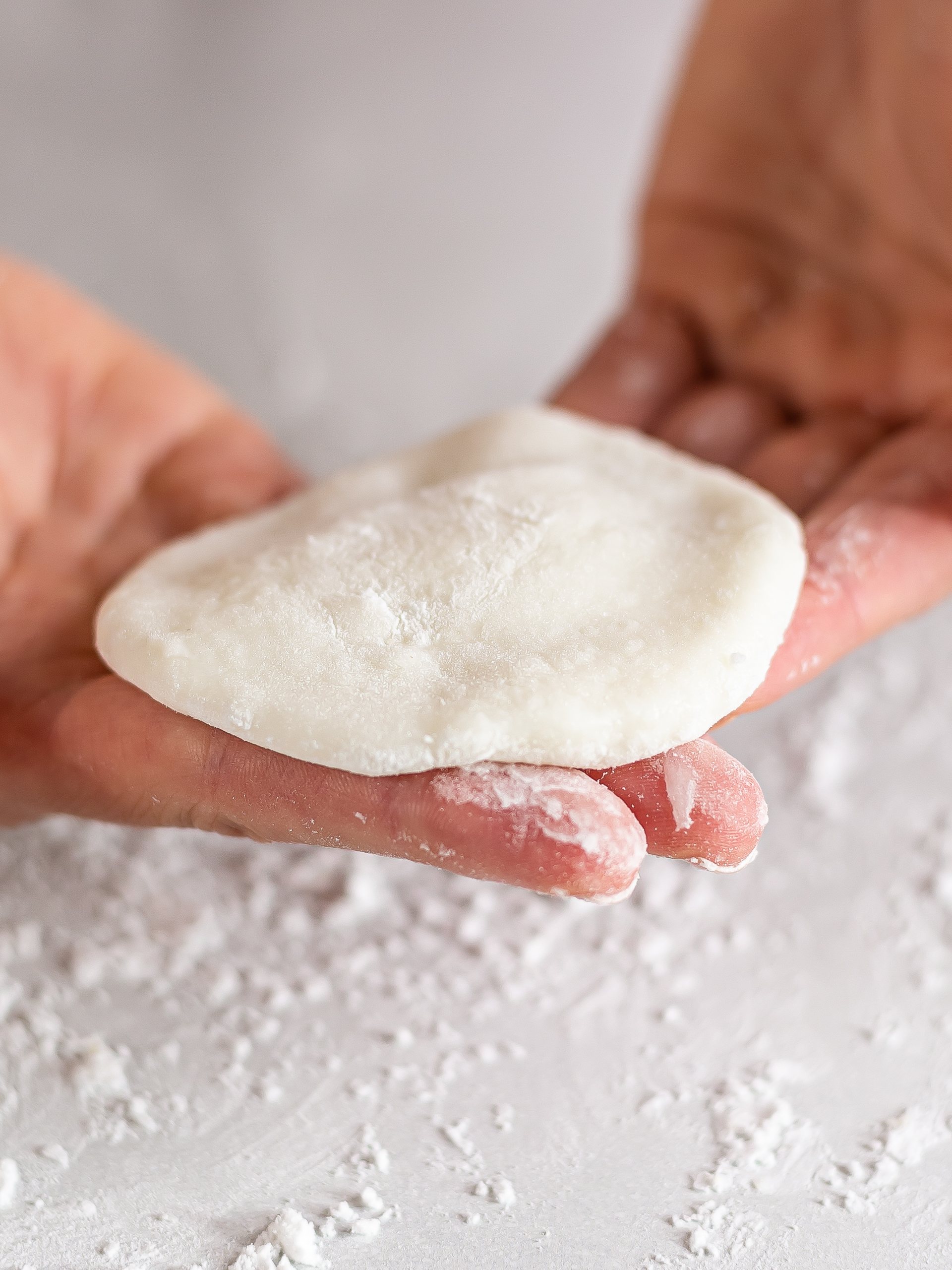 woman showing a mochi dough wrapper disc