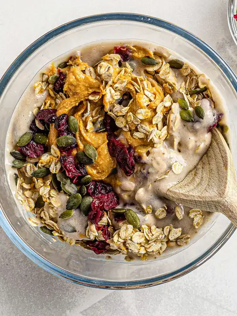 peanut butter with oats seeds and craberries in a bowl