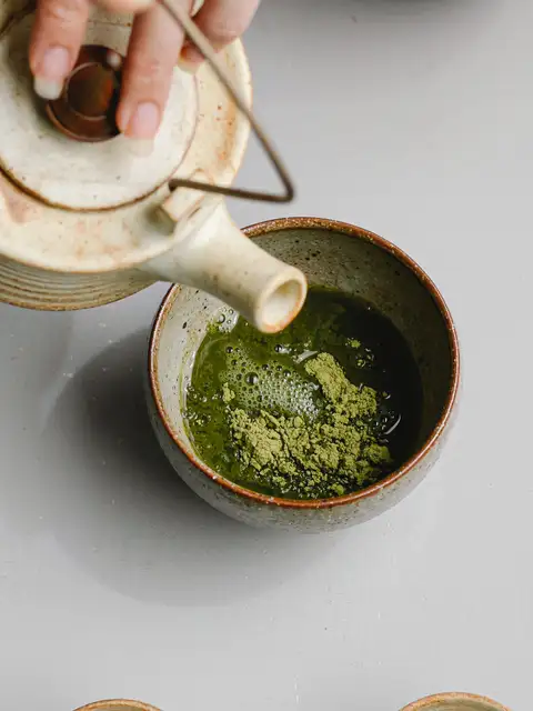 matcha powder and tea in a cup