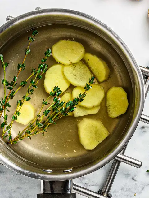 fresh ginger slices simmering in water for ginger tea
