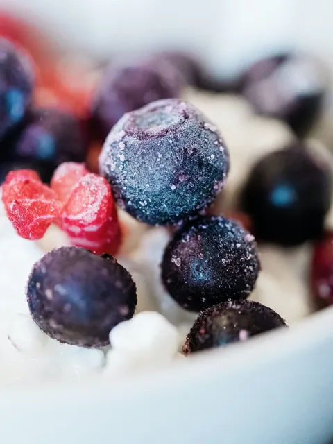 close up of frozen blueberries on yogurt