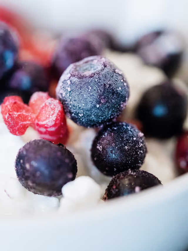 close up of frozen blueberries on yogurt